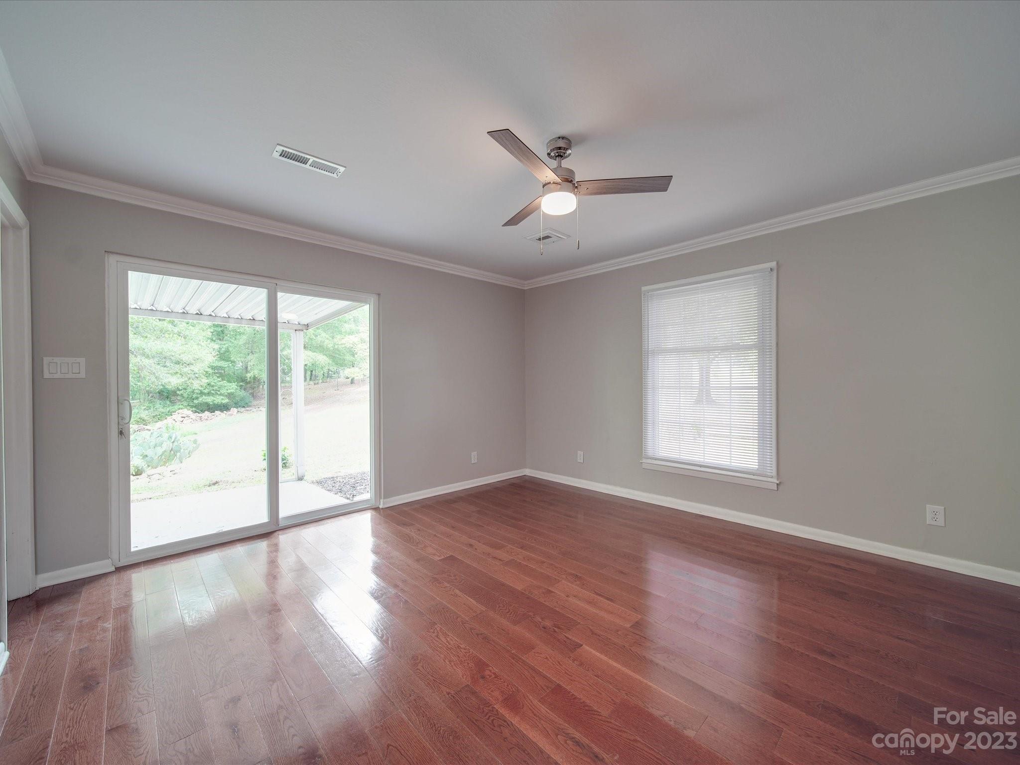 1035 Blake Road Albemarle, NC 28001 - Photo 23 of 45 a view of an empty room with wooden floor and a window