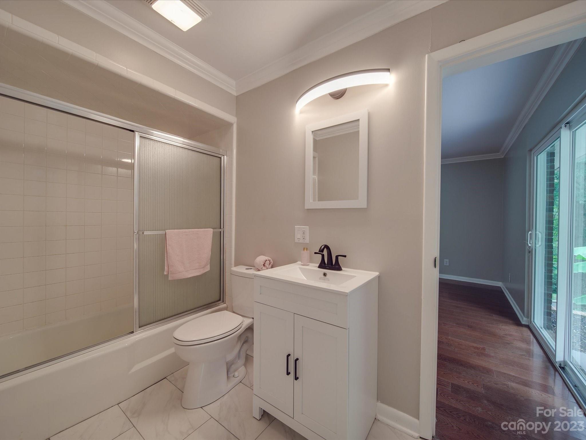1035 Blake Road Albemarle, NC 28001 - Photo 26 of 45 a bathroom with a toilet a sink and mirror