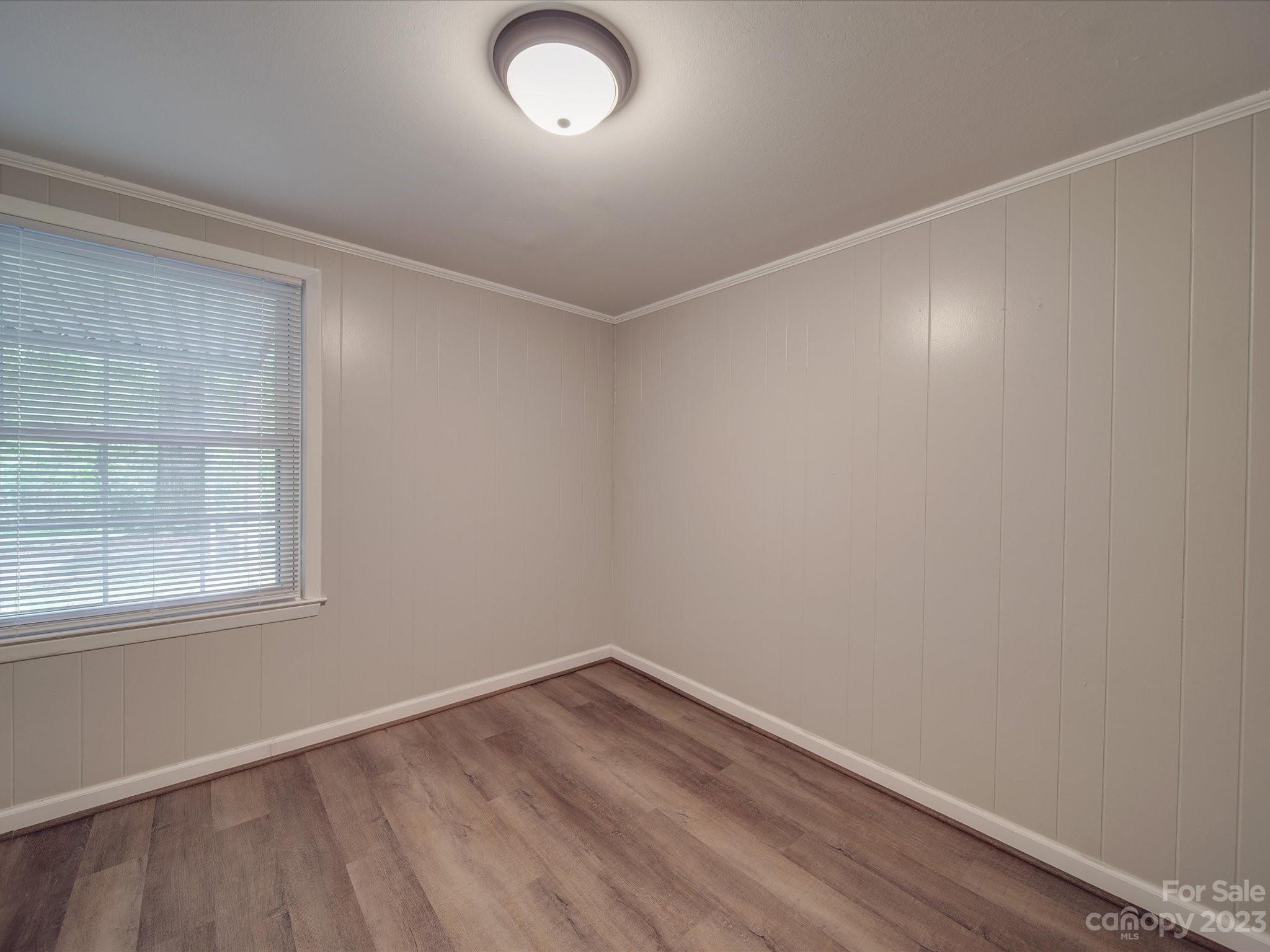 1035 Blake Road Albemarle, NC 28001 - Photo 31 of 45 an empty room with wooden floor and windows