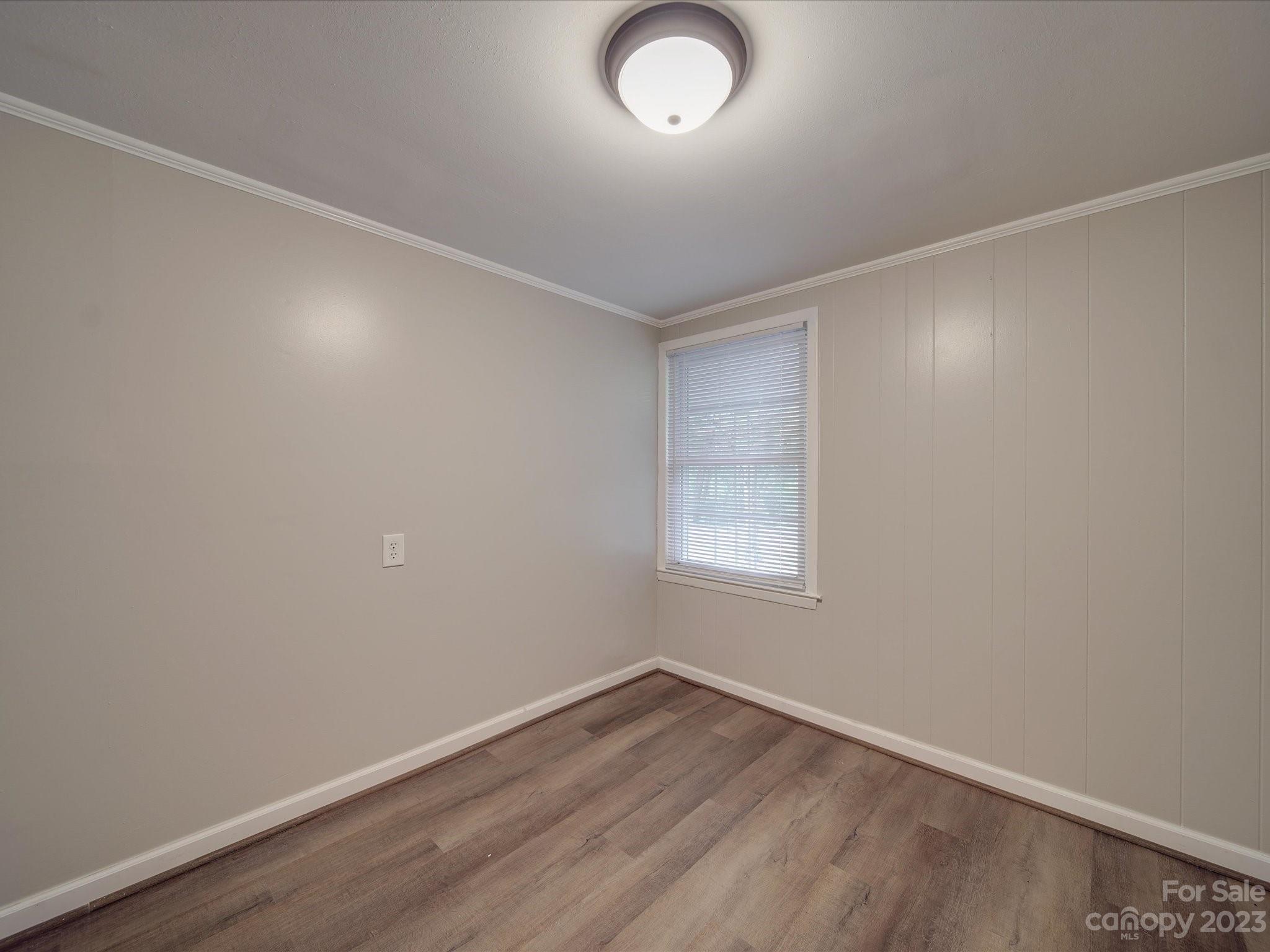 1035 Blake Road Albemarle, NC 28001 - Photo 33 of 45 an empty room with wooden floor and windows
