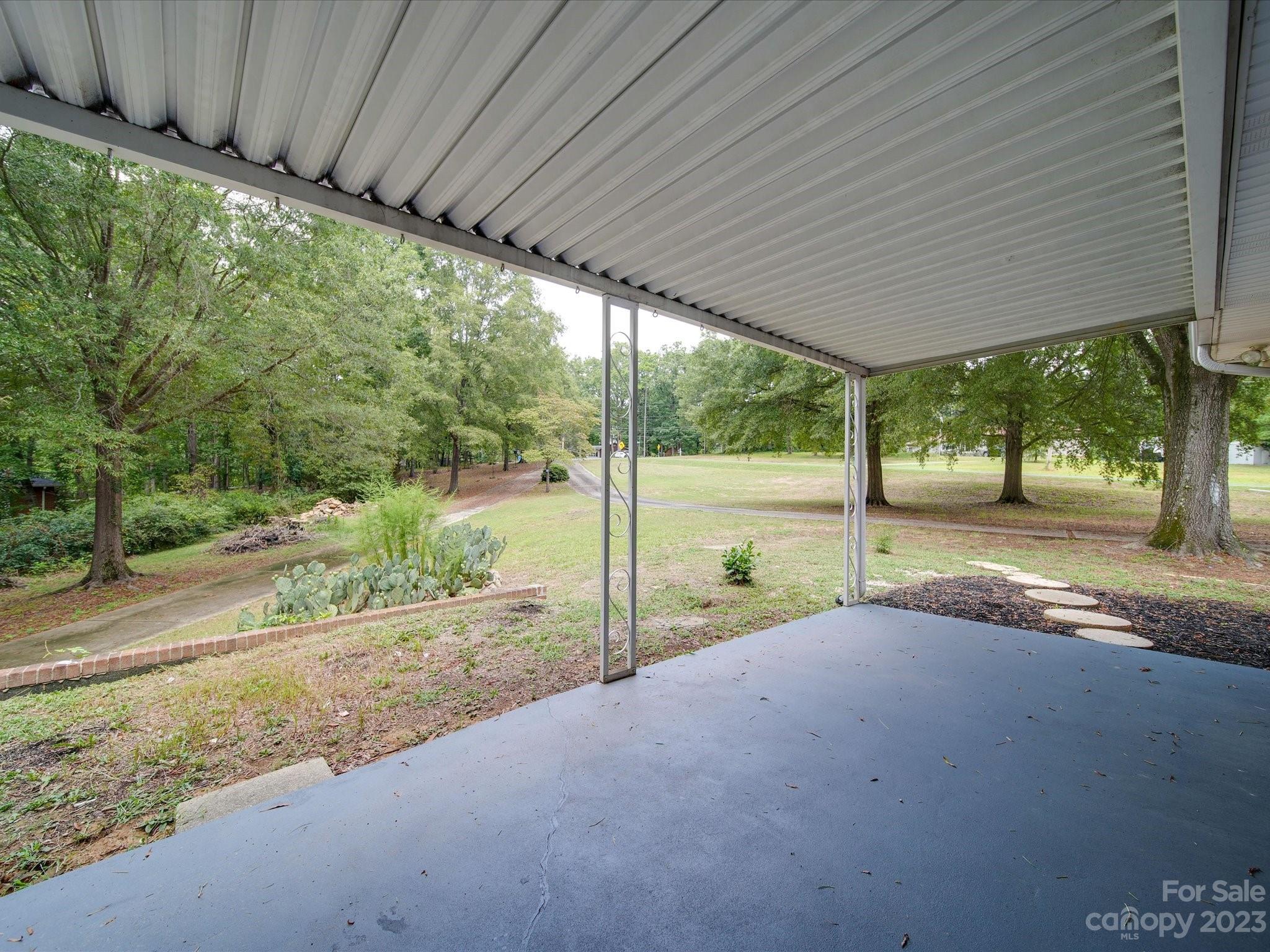 1035 Blake Road Albemarle, NC 28001 - Photo 38 of 45 a view of a house with backyard and a porch