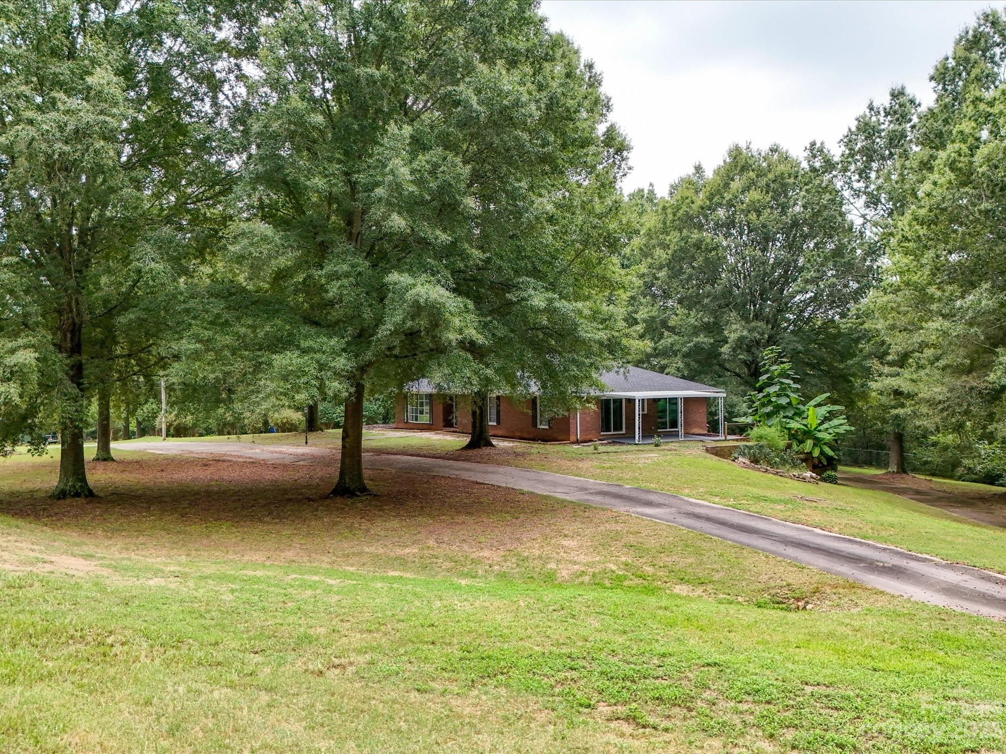 1035 Blake Road Albemarle, NC 28001 - Photo 39 of 45 a view of a house with a yard and large trees