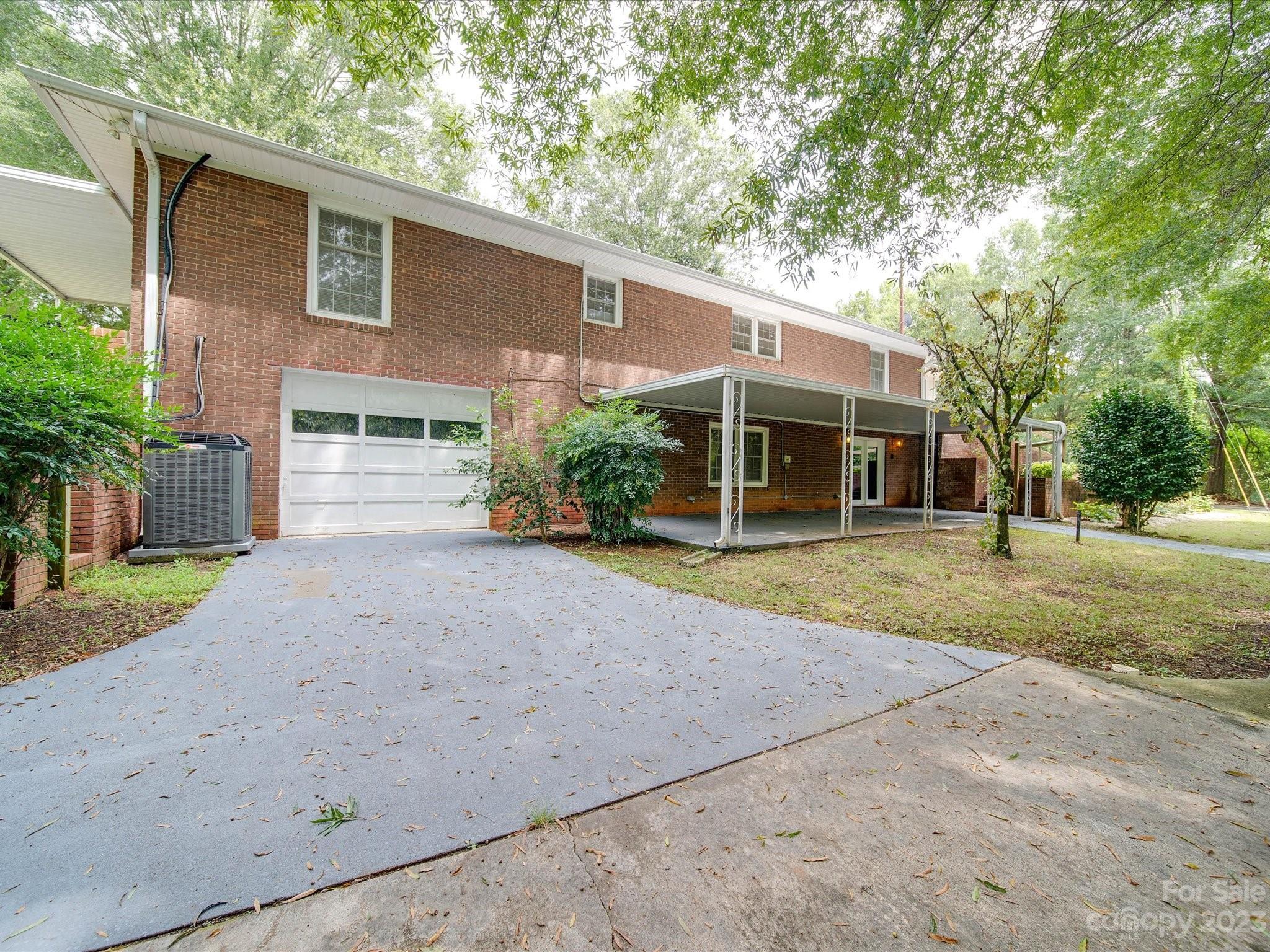 1035 Blake Road Albemarle, NC 28001 - Photo 41 of 45 a front view of a house with a yard and potted plants
