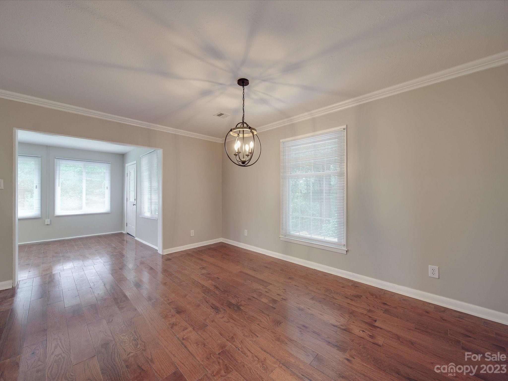 1035 Blake Road Albemarle, NC 28001 - Photo 7 of 45 an empty room with wooden floor and windows