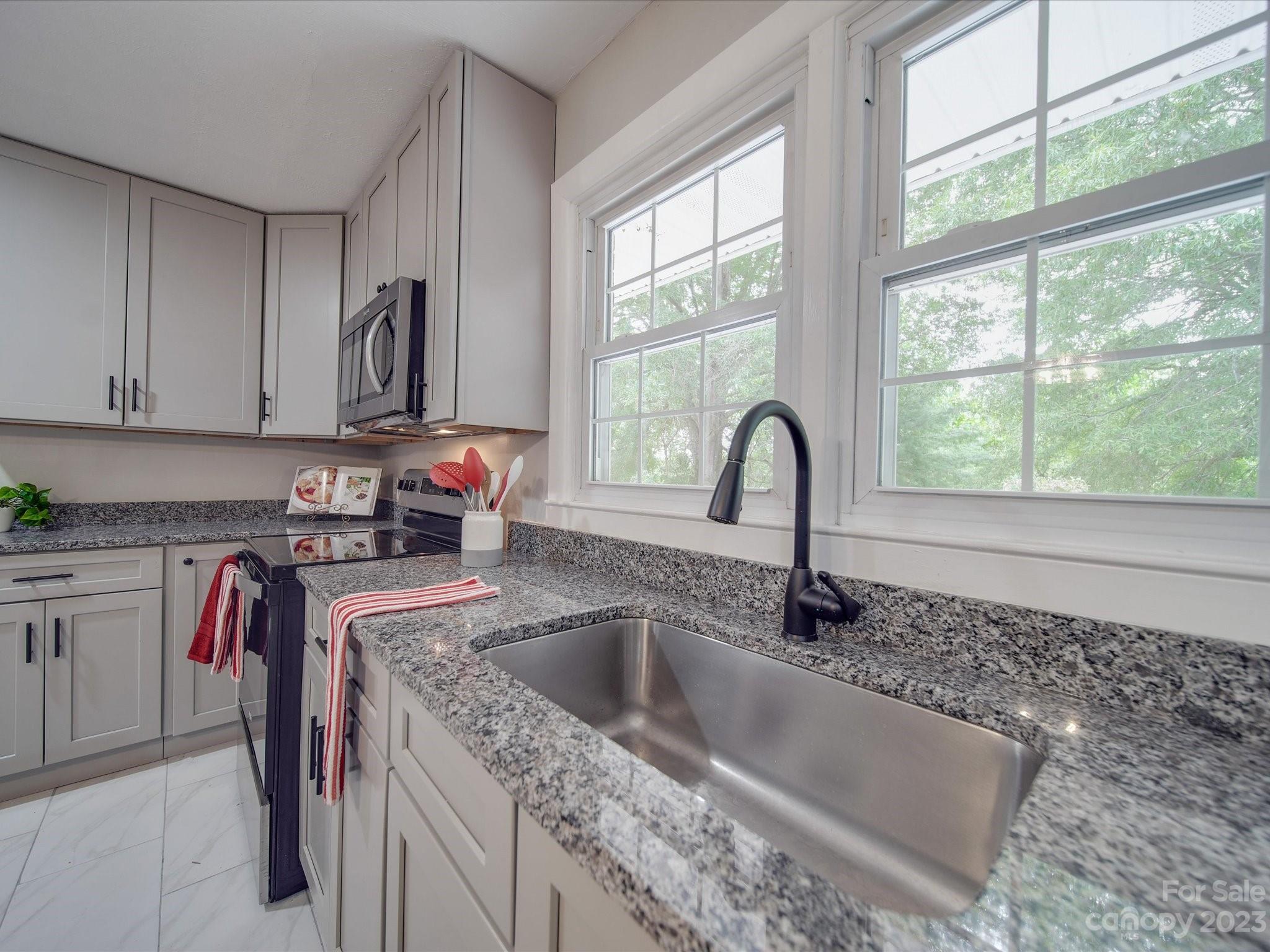 1035 Blake Road Albemarle, NC 28001 - Photo 10 of 45 a kitchen with granite countertop a sink and a window