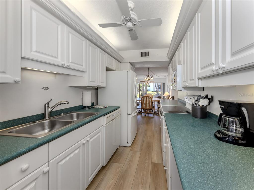1555 Tarpon Center Drive, Unit 132 Venice, FL 34285 - Photo 19 of 58 a kitchen with sink a stove and cabinets