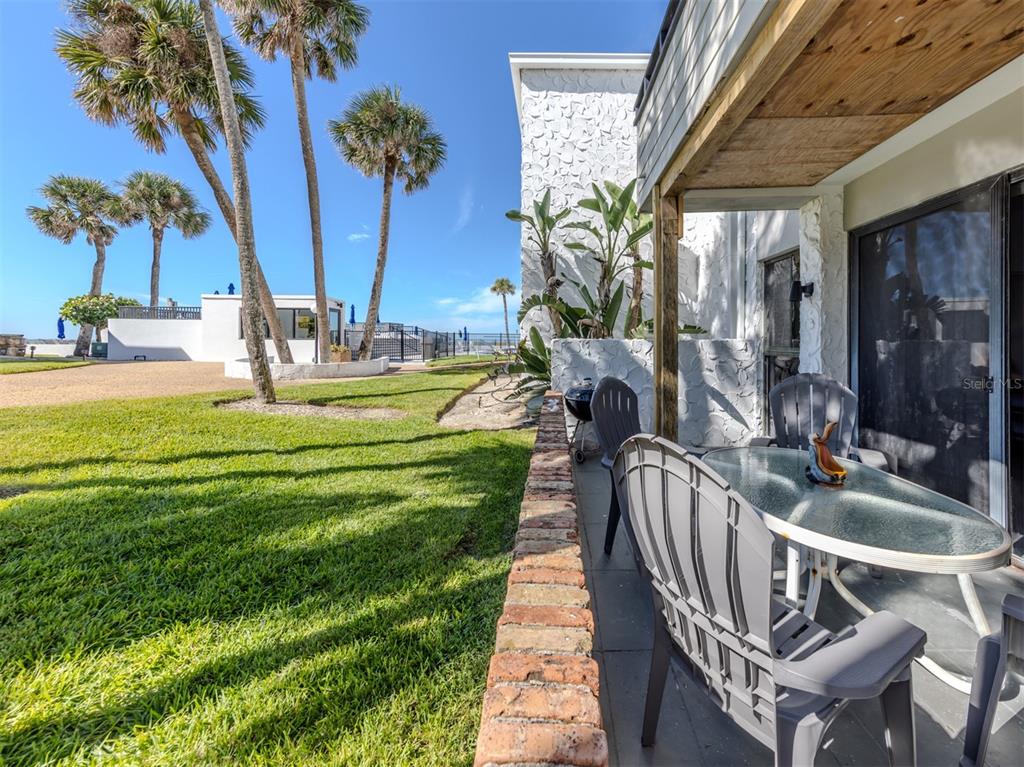1555 Tarpon Center Drive, Unit 132 Venice, FL 34285 - Photo 2 of 58 a swimming pool with barbeque oven and outdoor seating