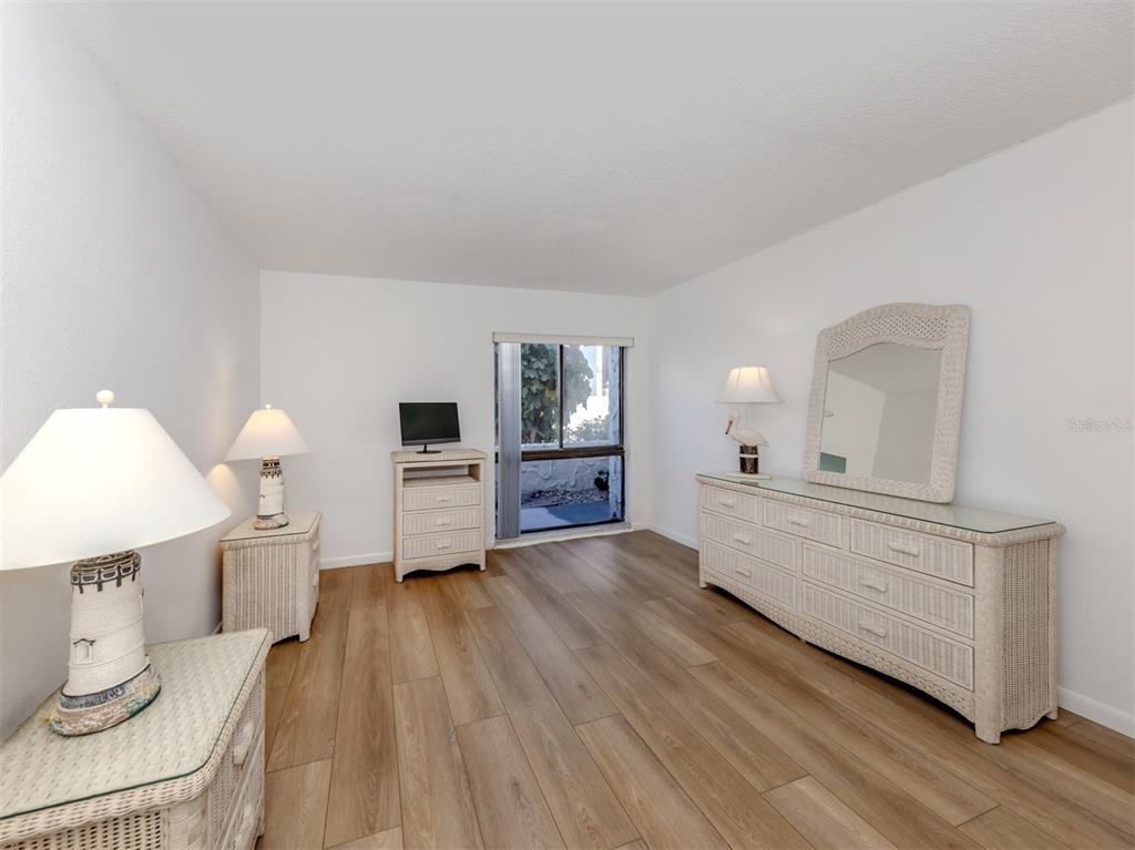 1555 Tarpon Center Drive, Unit 132 Venice, FL 34285 - Photo 21 of 58 a living room with furniture and a wooden floor