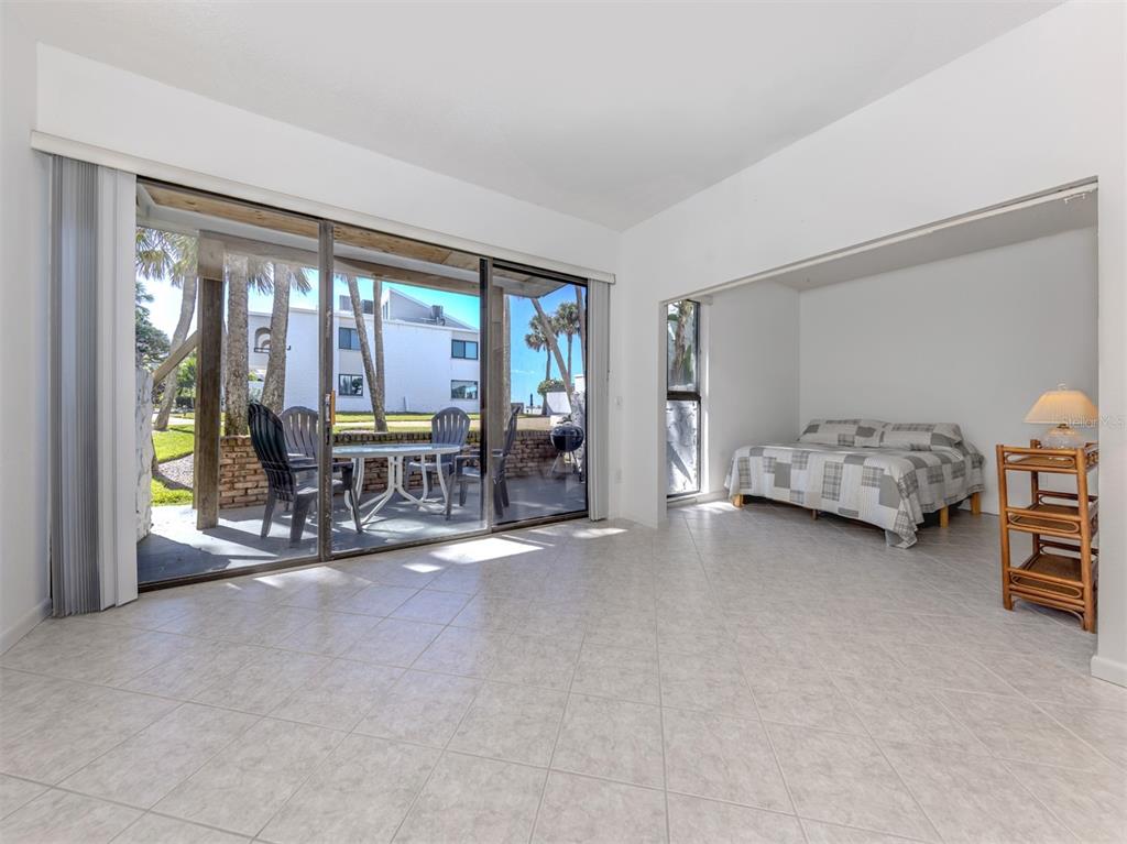 1555 Tarpon Center Drive, Unit 132 Venice, FL 34285 - Photo 24 of 58 a living room with furniture and large windows