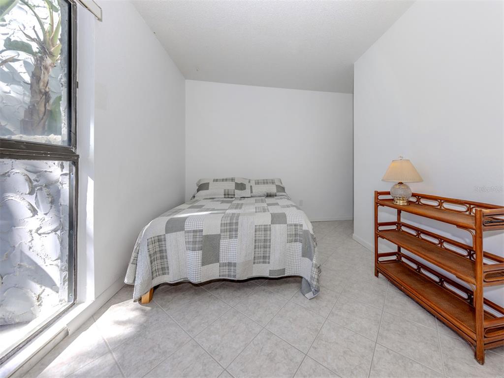1555 Tarpon Center Drive, Unit 132 Venice, FL 34285 - Photo 25 of 58 a bedroom with a bed and a window