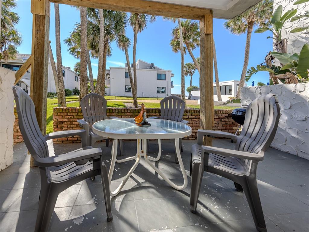 1555 Tarpon Center Drive, Unit 132 Venice, FL 34285 - Photo 3 of 58 a view of a dinning tables and chairs in the patio