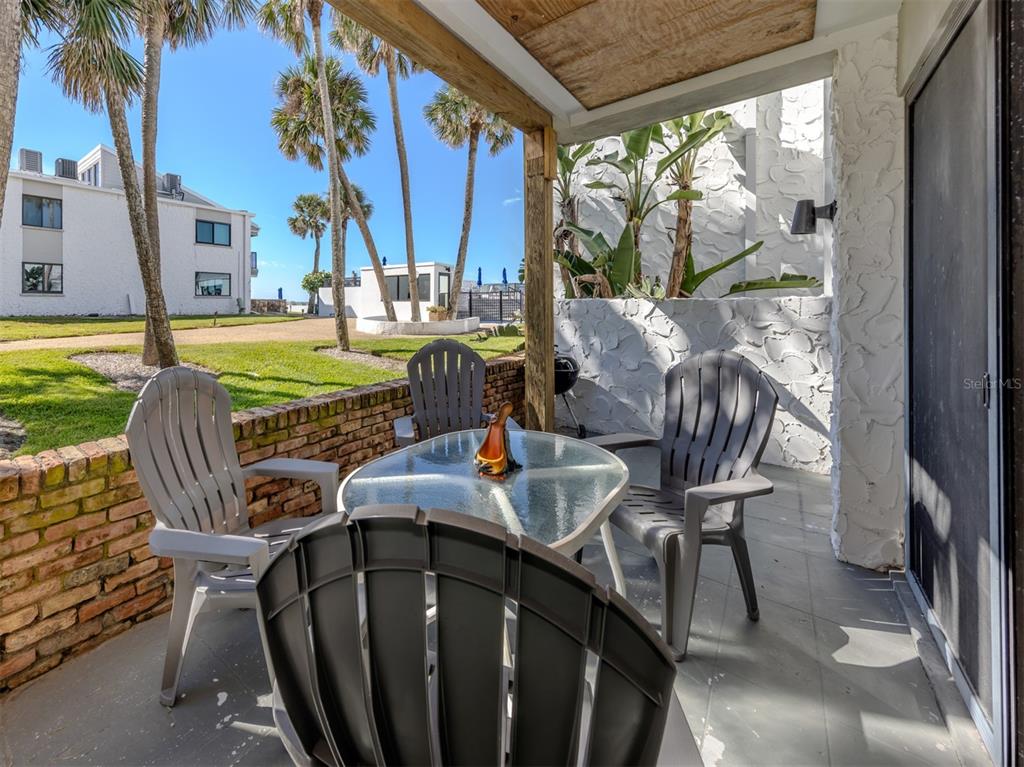 1555 Tarpon Center Drive, Unit 132 Venice, FL 34285 - Photo 4 of 58 a view of a patio with table and chairs and potted plants