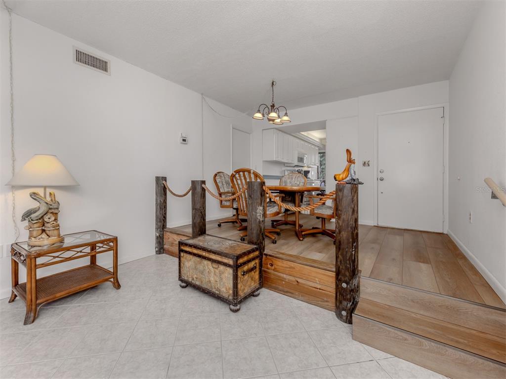 1555 Tarpon Center Drive, Unit 132 Venice, FL 34285 - Photo 10 of 58 a living room with furniture and a chandelier