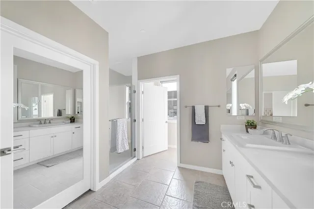 a spacious bathroom with a granite countertop sink mirror and shower