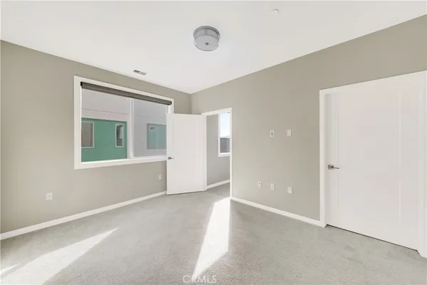 an empty room with windows and closet