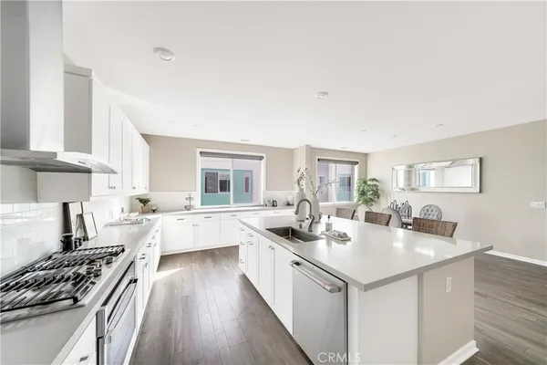 a kitchen with a sink stove and cabinets