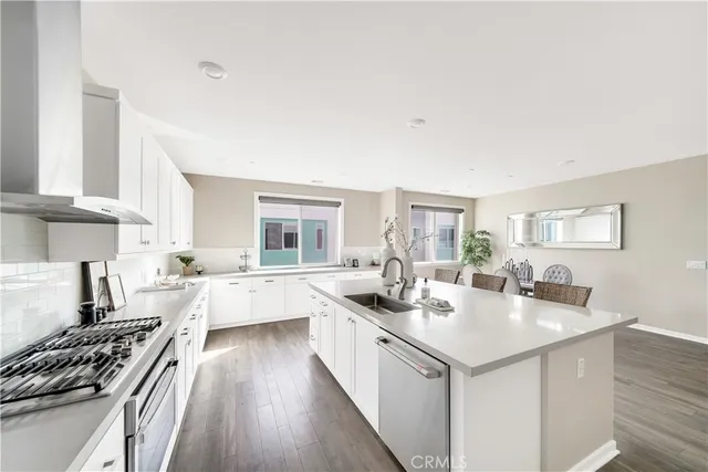 a kitchen with a sink stove and cabinets