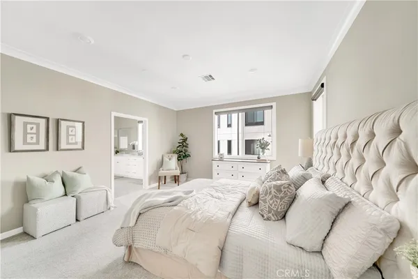 a bedroom with a large bed and a couch