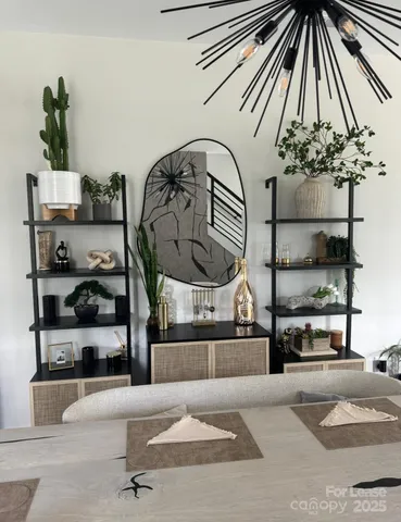 a room with a bed and a chandelier