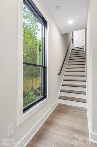 a view of entryway and hall with wooden floor
