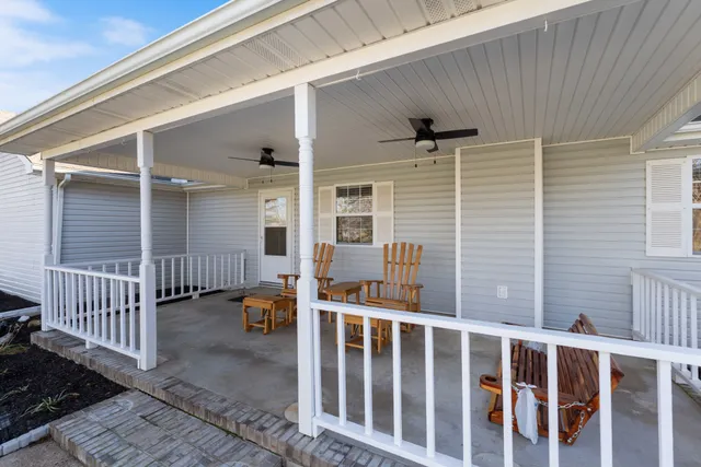 a big white house with a big yard and large trees