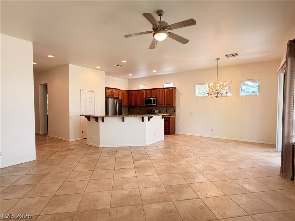 16 Caprington Road Henderson, NV 89052 - Photo 6 of 16 Tiled flooring and recessed lighting span this open layout connecting the main living spaces.