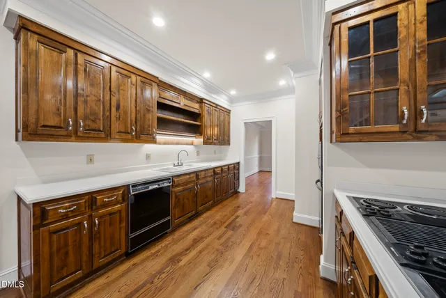 a bathroom with a granite countertop sink a toilet and mirror