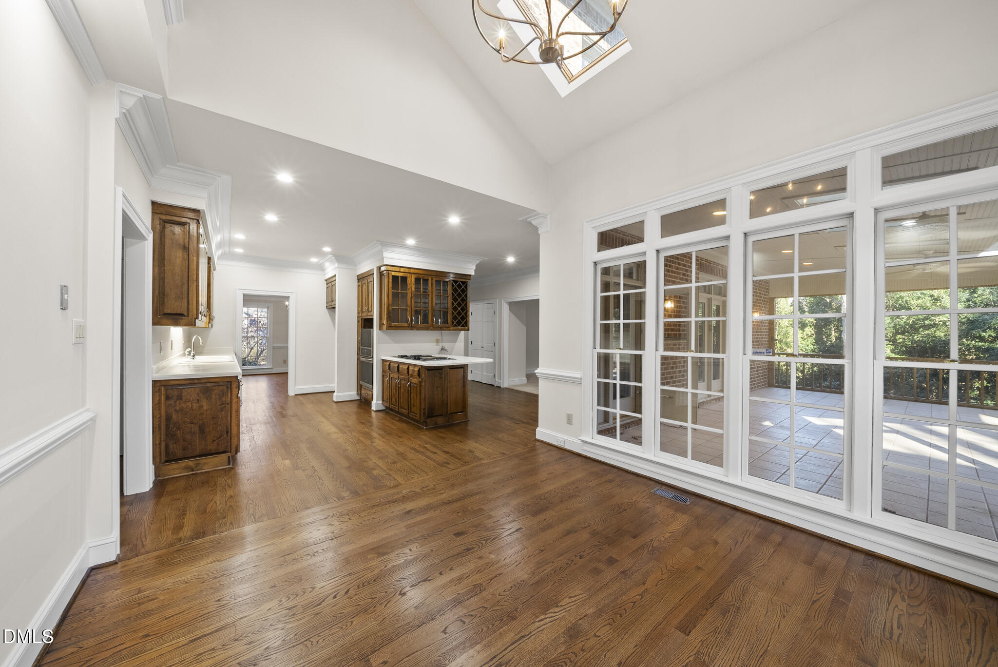 3812 City Of Oaks Wynd Raleigh, NC 27612 - Photo 32 of 79 a view of a big room with wooden floor and a kitchen