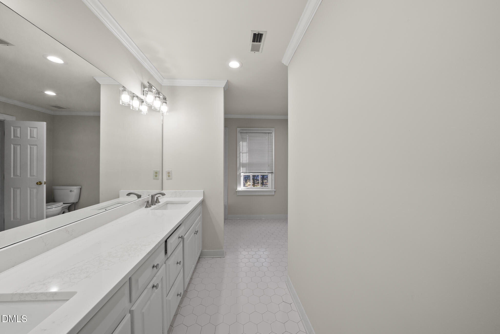 3812 City Of Oaks Wynd Raleigh, NC 27612 - Photo 66 of 79 a bathroom with a double vanity sink and mirror