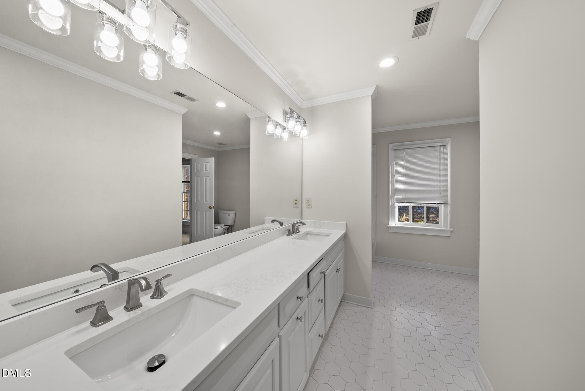 3812 City Of Oaks Wynd Raleigh, NC 27612 - Photo 67 of 79 a spacious bathroom with a double vanity sink a mirror and a shower