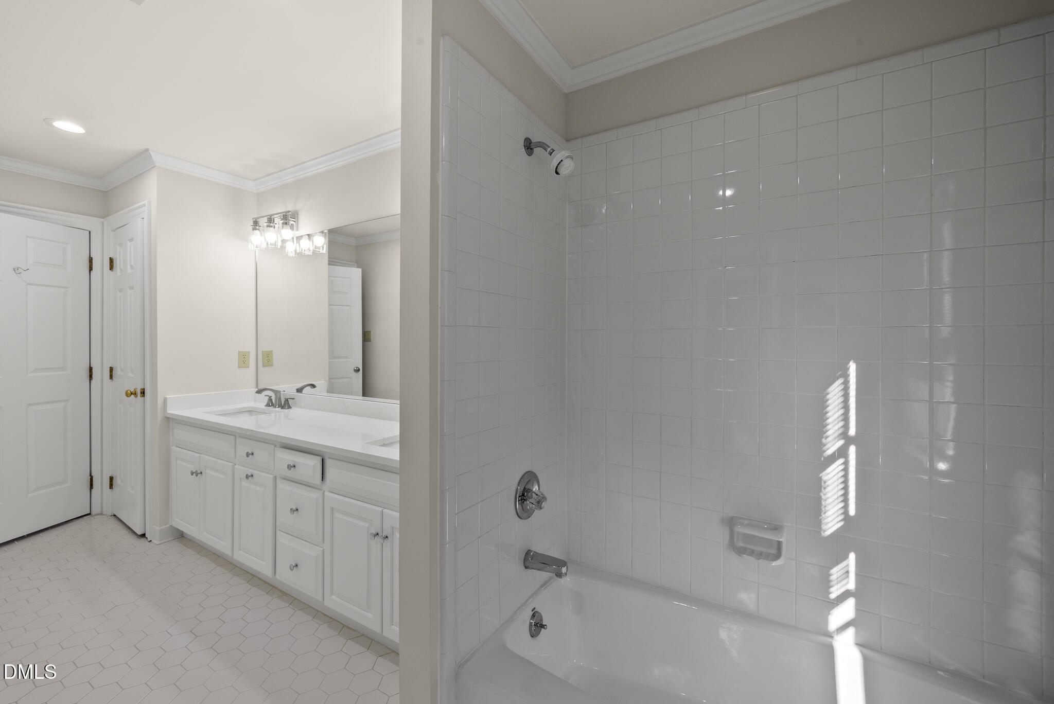 3812 City Of Oaks Wynd Raleigh, NC 27612 - Photo 68 of 79 a bathroom with a double vanity sink and mirror with shower