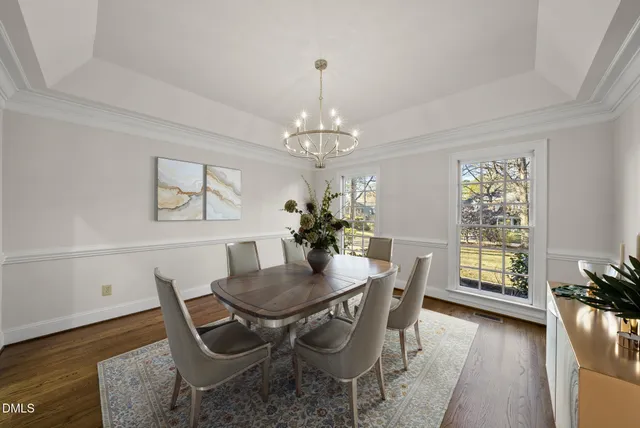 a living room with furniture a fireplace and a ceiling fan