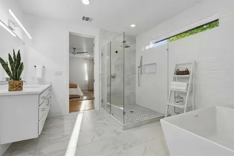a bathroom with a bathtub shower sink and toilet
