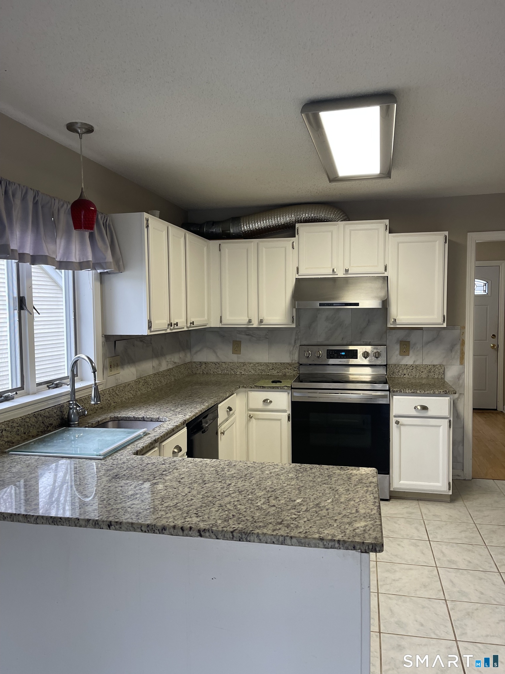 163 Trotters Way Torrington, CT 06790 - Photo 12 of 23 a kitchen with a sink stove and cabinets