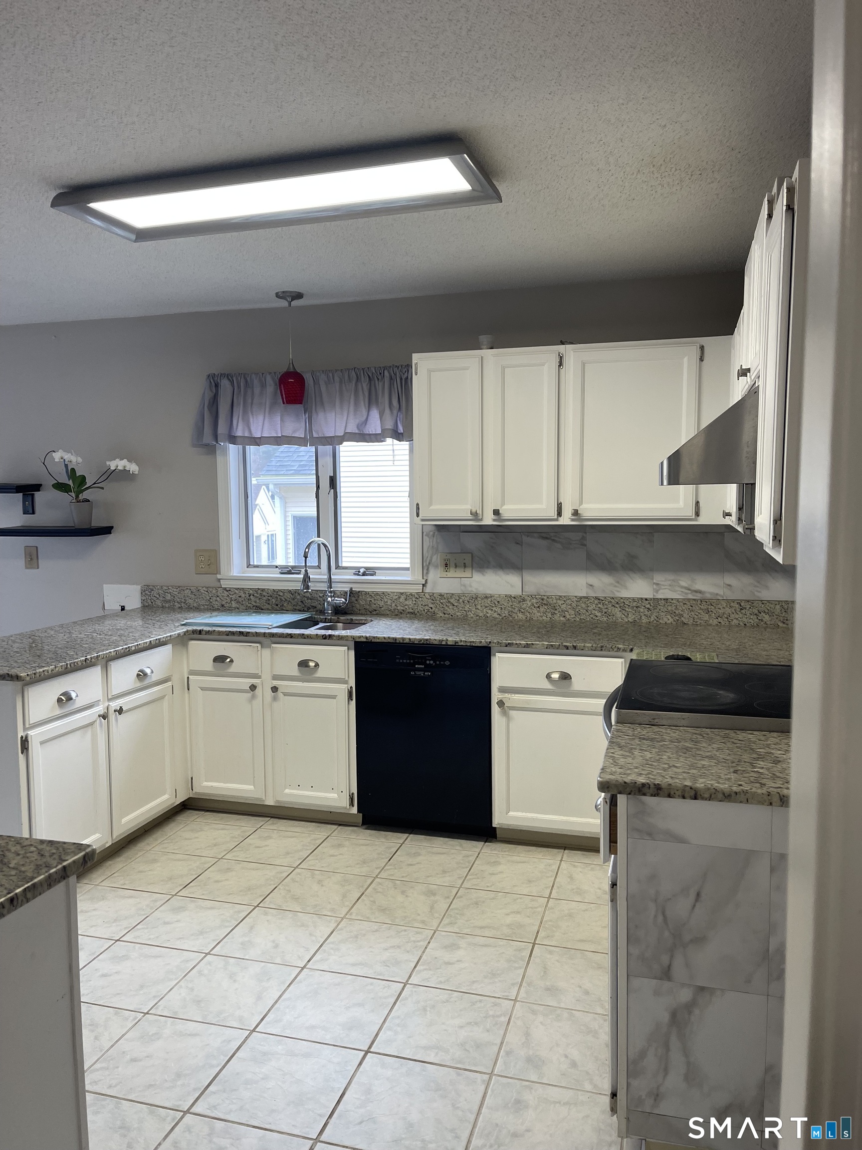 163 Trotters Way Torrington, CT 06790 - Photo 13 of 23 a kitchen with a sink window and cabinets