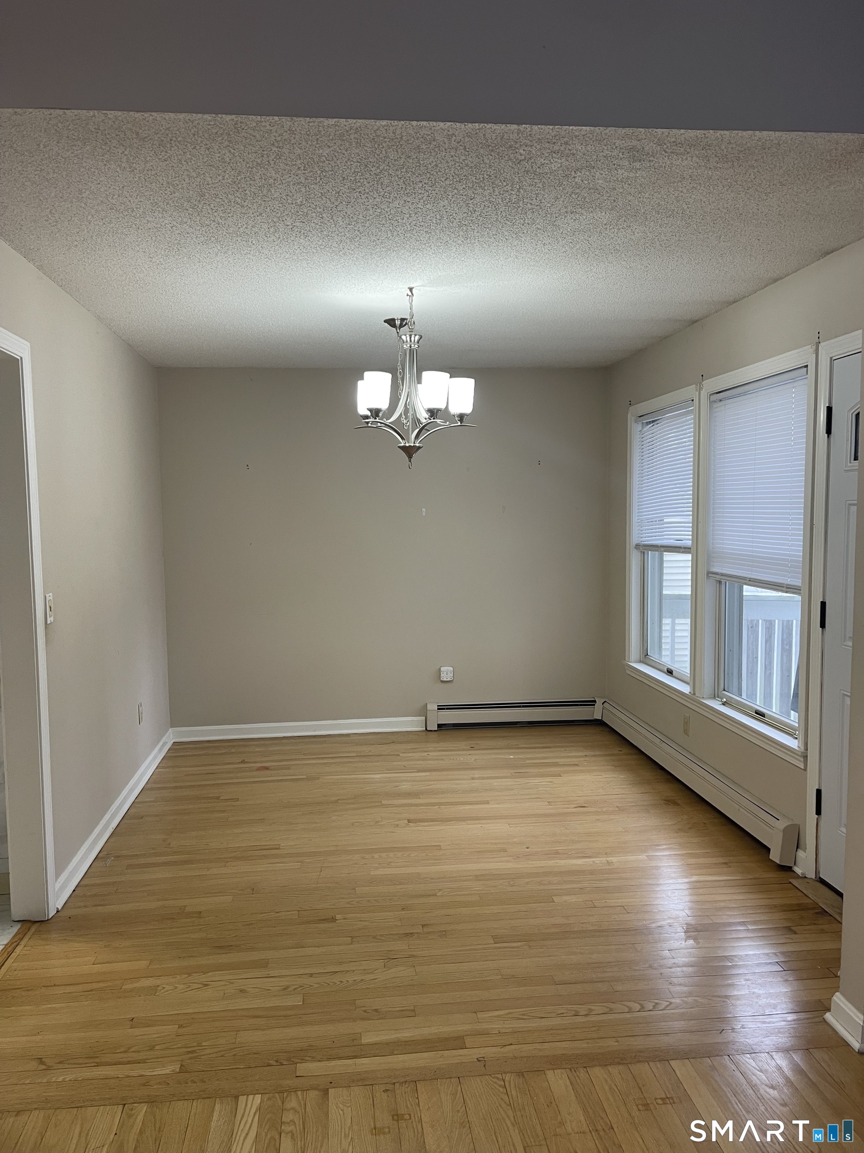 163 Trotters Way Torrington, CT 06790 - Photo 16 of 23 an empty room with wooden floor