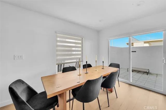 a living room with furniture a fireplace and wooden floor