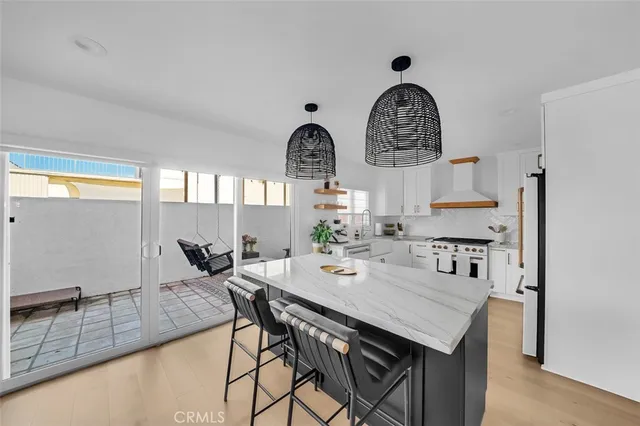 a view of kitchen with sink dining table and chairs