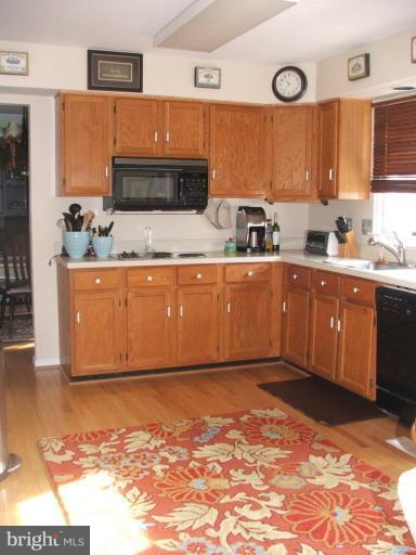 9537 Hallhurst Road Nottingham, MD 21236 - Photo 2 of 14 a large kitchen with stainless steel appliances granite countertop a sink and cabinets