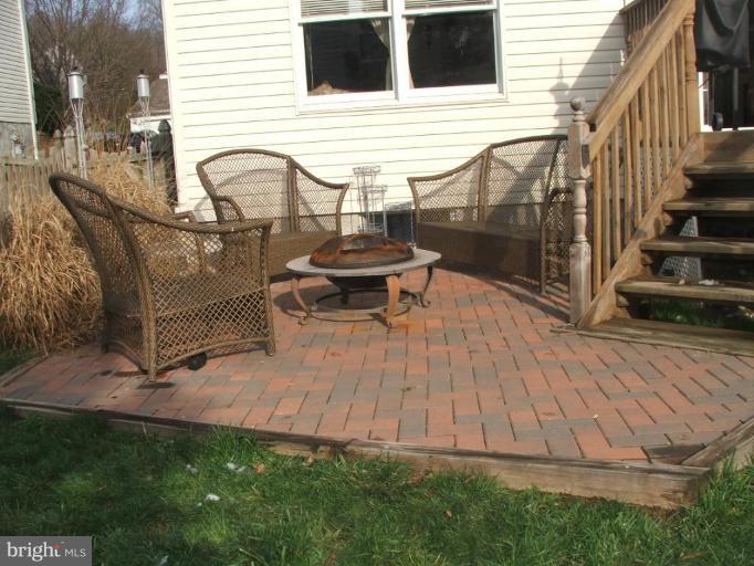 9537 Hallhurst Road Nottingham, MD 21236 - Photo 11 of 14 a view of a chair and table in the backyard