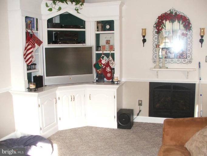 9537 Hallhurst Road Nottingham, MD 21236 - Photo 4 of 14 a living room with furniture and a fireplace