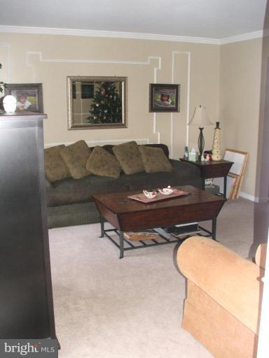 9537 Hallhurst Road Nottingham, MD 21236 - Photo 7 of 14 a living room with furniture and a table