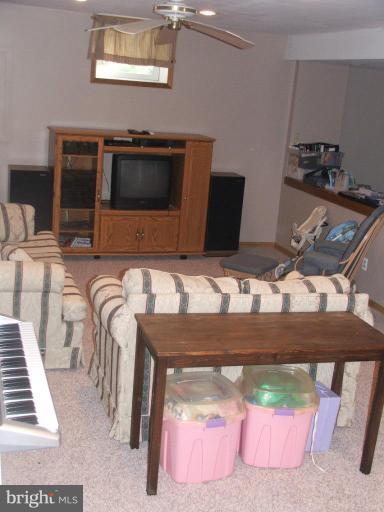 9537 Hallhurst Road Nottingham, MD 21236 - Photo 8 of 14 a living room with furniture and a flat screen tv