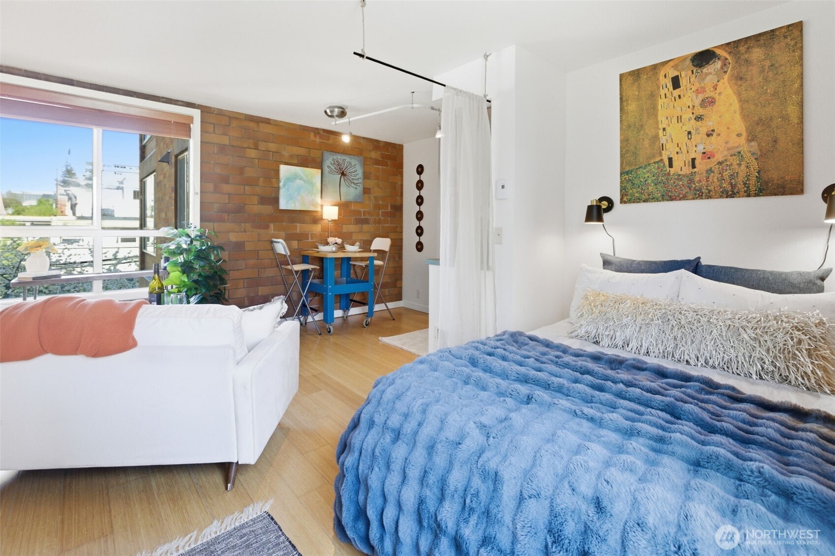 905 Cherry Street, Unit 306 Seattle, WA 98104 - Photo 12 of 25 a bedroom with a large bed and a wooden floor