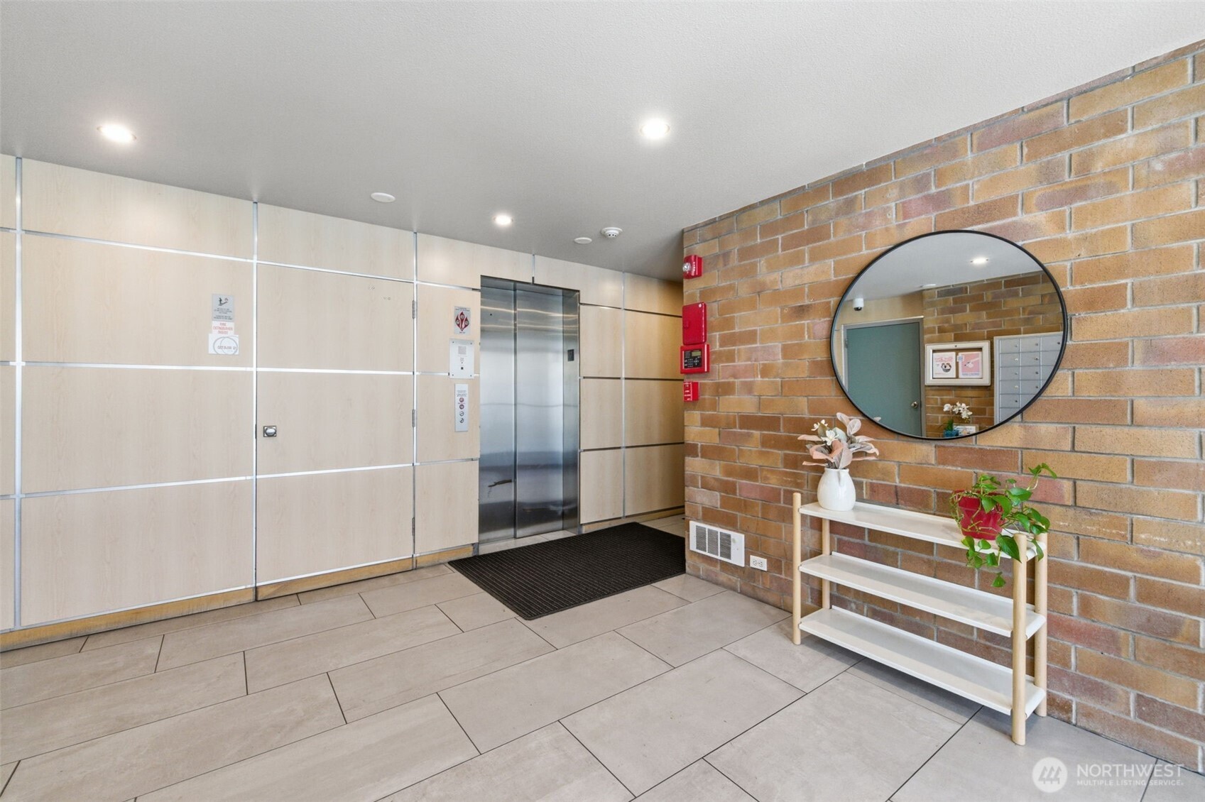 905 Cherry Street, Unit 306 Seattle, WA 98104 - Photo 15 of 25 a bathroom with a mirror and a shower