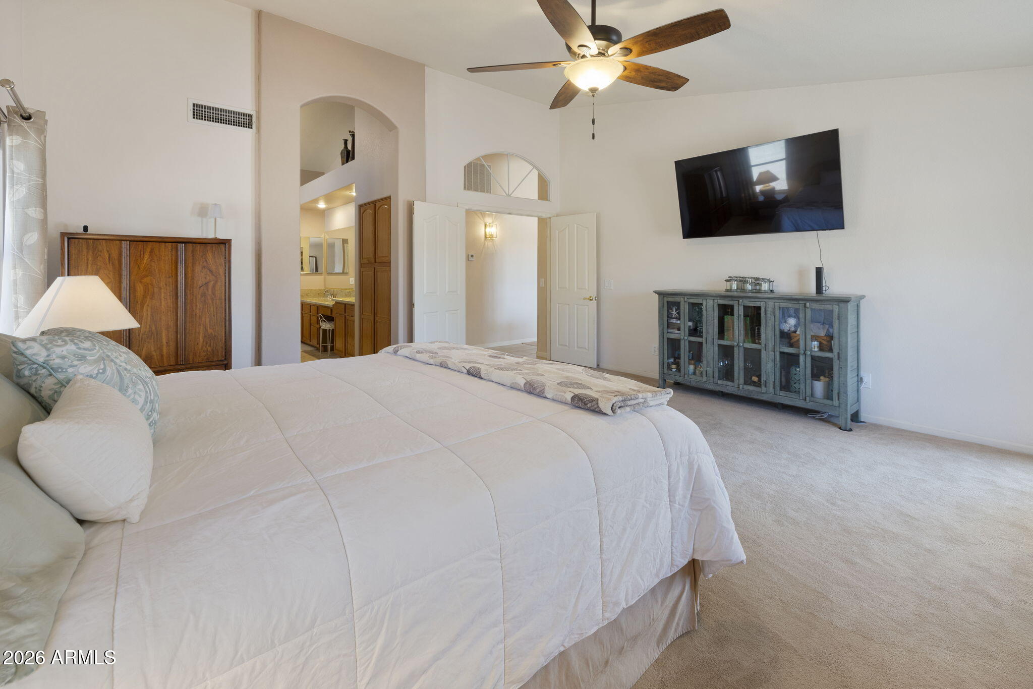 12435 West Monte Vista Road Avondale, AZ 85392 - Photo 37 of 69 a bedroom with a bed and a flat screen tv
