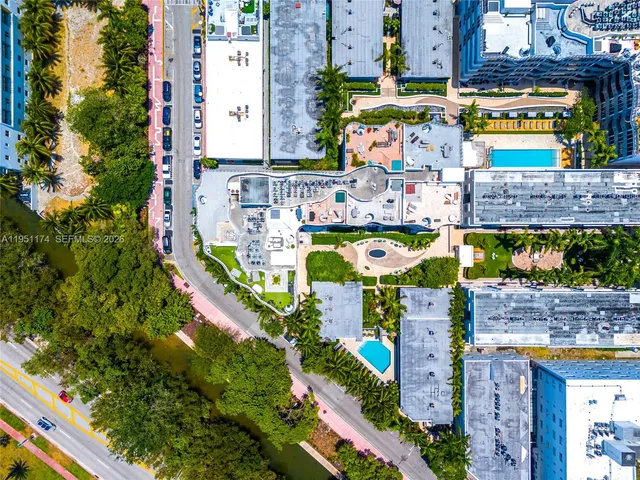 an aerial view of a swimming pool with outdoor seating