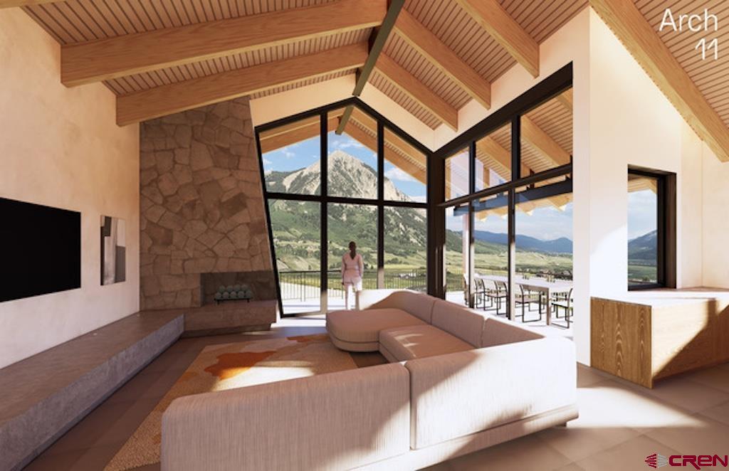 565 Saddle Ridge Ranch Road Crested Butte, CO 81224 - Photo 16 of 35 a bedroom with a bed and a flat tv screen on the dresser