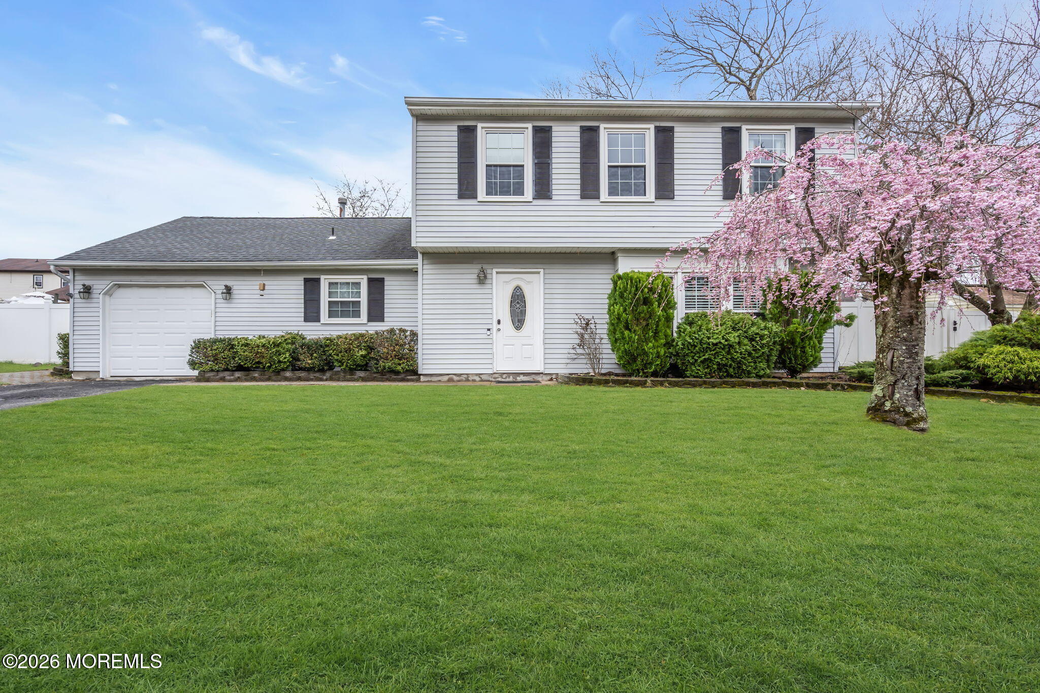 24 Eric Drive Howell, NJ 07731 - Photo 1 of 58 a front view of a house with a garden