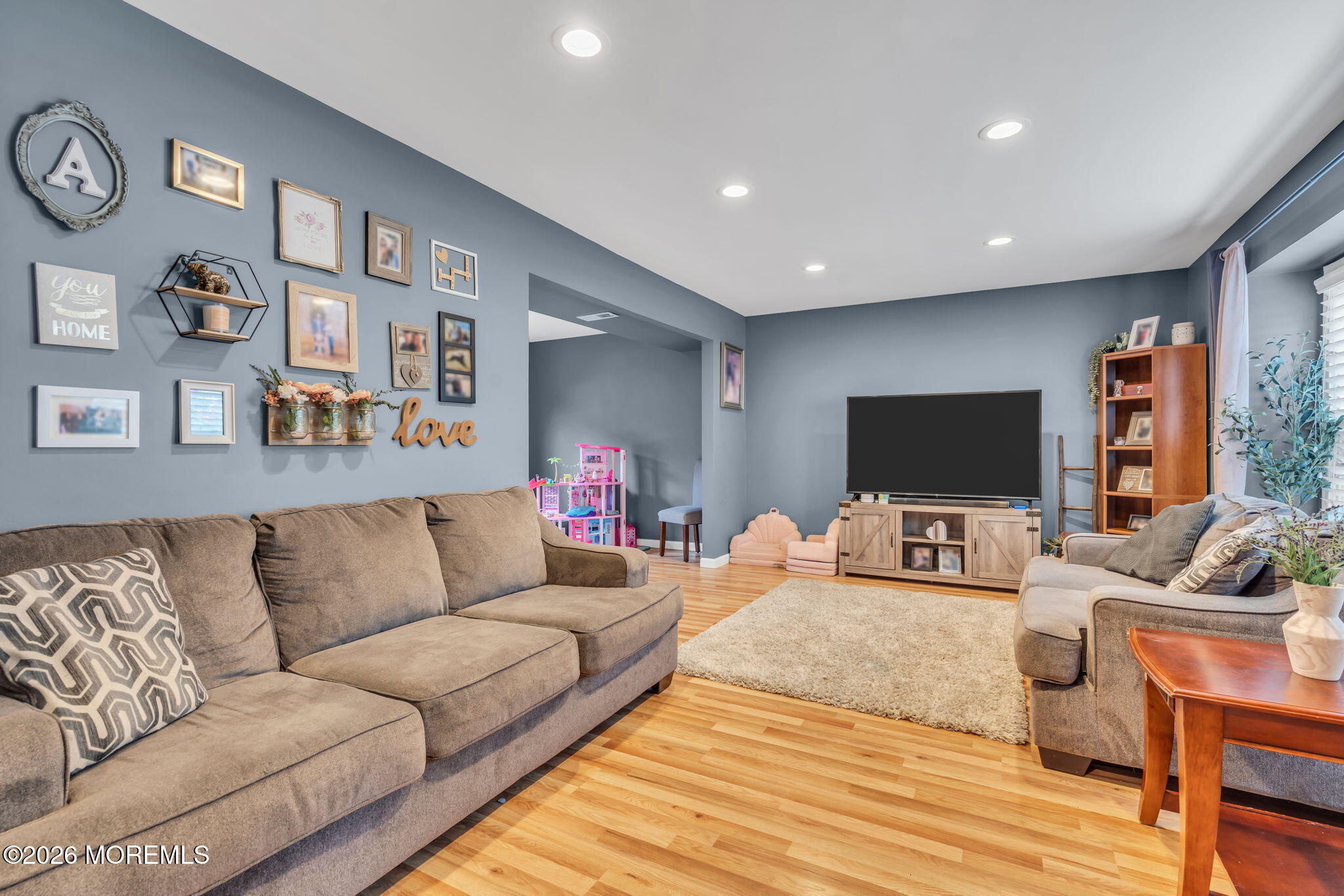 24 Eric Drive Howell, NJ 07731 - Photo 12 of 58 a living room with furniture and a flat screen tv